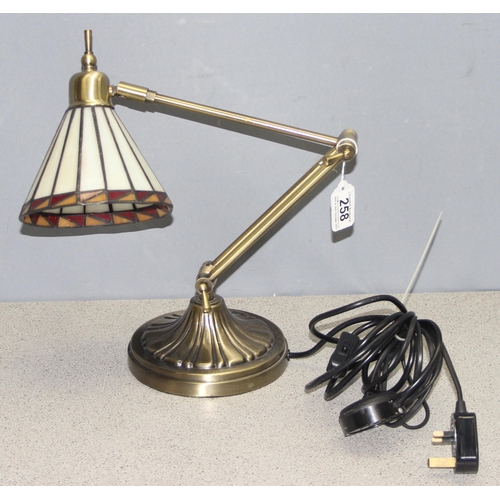 258 - An adjustable brass desk lamp with Tiffany style shade, approx 50cm when extended