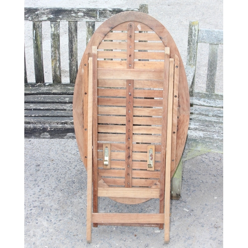 325 - 2 weathered teak weathered garden benches and a folding teak table, largest approx 150cm W x 85cm H ... 