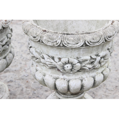 329 - A pair of decorative cast concrete classical style garden urns with floral design, each approx 45cm ... 