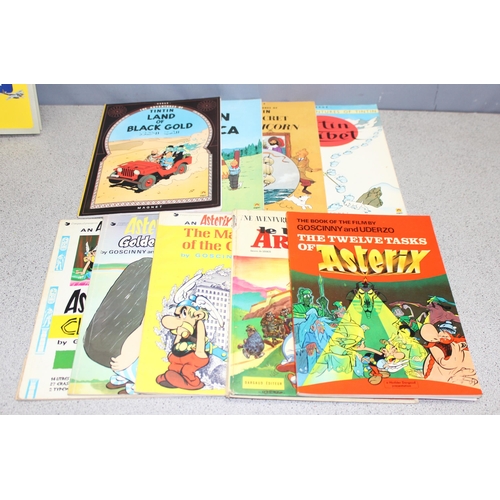 513 - Box of mostly collectable toy reference books and some Tintin and Asterix vintage comic strip books