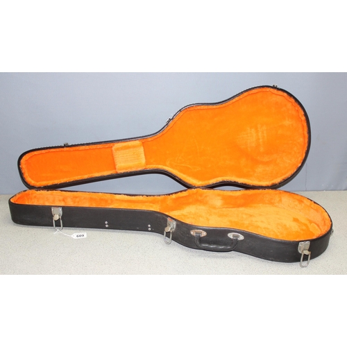 609 - Black hard-shell guitar case, approx 104cm