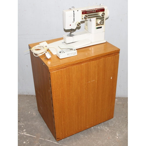 812 - New Home automatic sewing machine mounted on cabinet, with some contents, approx 61cm wide x 47cm de... 