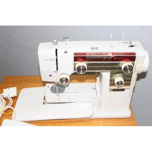 812 - New Home automatic sewing machine mounted on cabinet, with some contents, approx 61cm wide x 47cm de... 