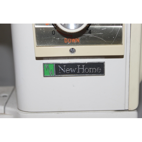 812 - New Home automatic sewing machine mounted on cabinet, with some contents, approx 61cm wide x 47cm de... 