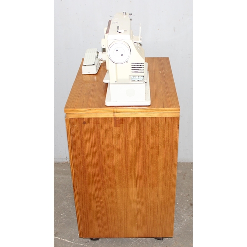 812 - New Home automatic sewing machine mounted on cabinet, with some contents, approx 61cm wide x 47cm de... 