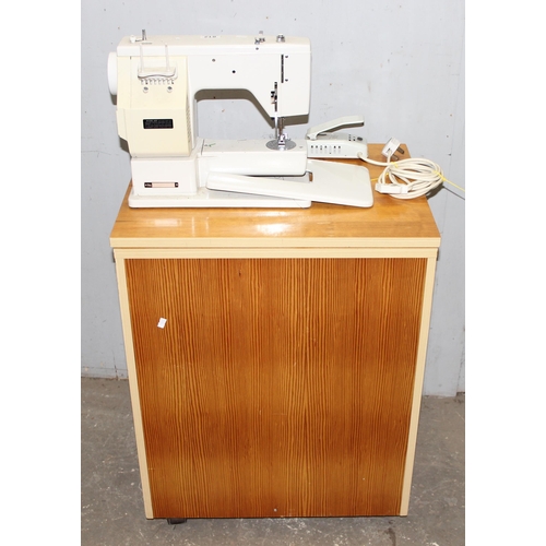 812 - New Home automatic sewing machine mounted on cabinet, with some contents, approx 61cm wide x 47cm de... 