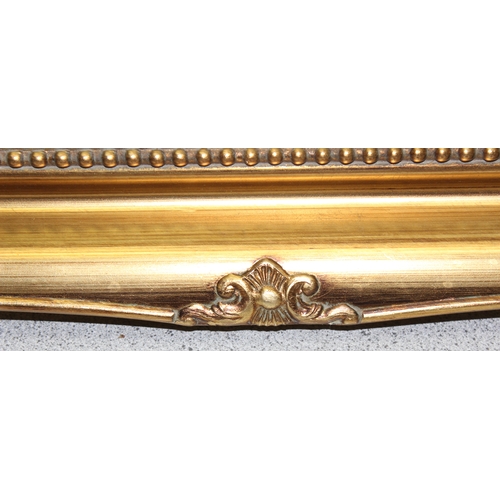 442 - Gilt framed wall mirror with classical decoration, approx 90cm x 65cm