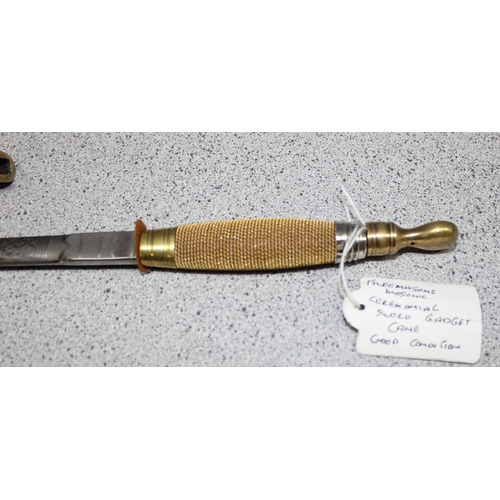 1424 - A tapering walking cane with hollow centre housing a deconstructed Masonic Sword with engraved decor... 