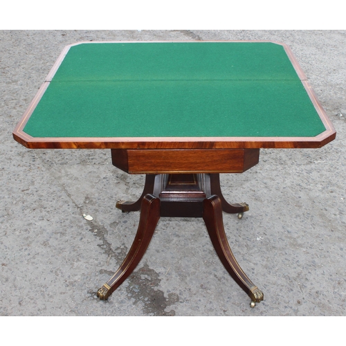 170 - An antique mahogany card table with fold over top, baize lined interior and  games, approx 90cm wide... 