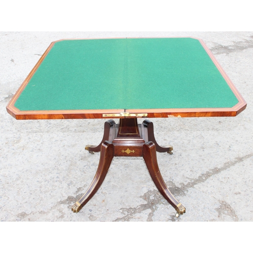 170 - An antique mahogany card table with fold over top, baize lined interior and  games, approx 90cm wide... 