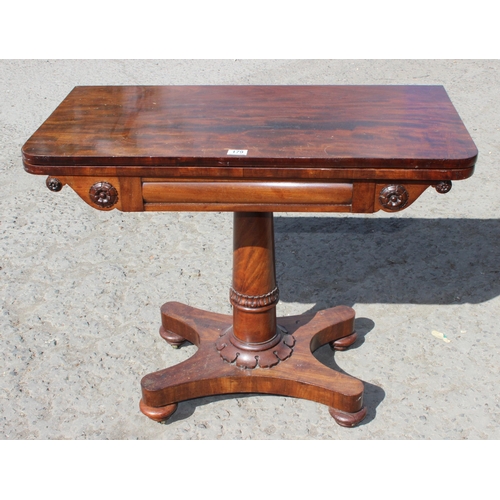 179 - A Regency period mahogany tea table with fold over tops and carved pedestal base, approx 92cm wide x... 