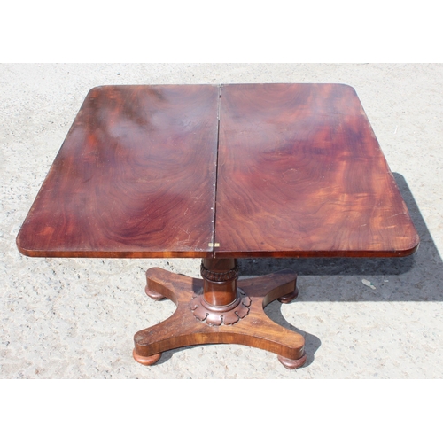 179 - A Regency period mahogany tea table with fold over tops and carved pedestal base, approx 92cm wide x... 