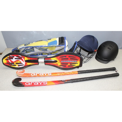 714 - Qty of sporting equipment to include Junior cricket pads, cricket helmet and 2 hockey sticks