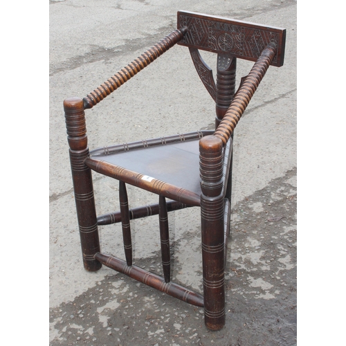 8 - An unusual antique Turner's corner chair with bobbin turned arms and carved back details, likely lat... 