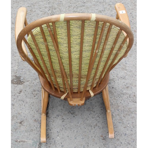 3 - A vintage blonde Ercol rocking chair with stick back and cushions, original blue & gold label, appro... 