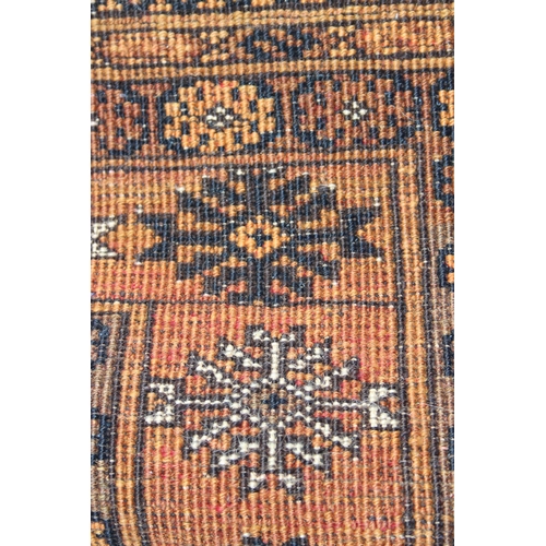 224 - A vintage yellow and dark blue ground hand made Persian rug, approx 173cm x 107cm