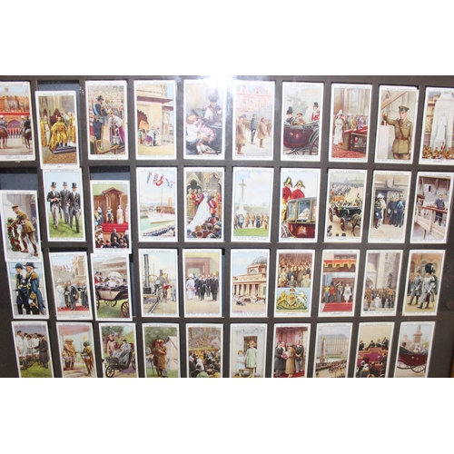 460N - Framed Wills cigarette cards celebrating The Reign of King George V 1935, approx 50cm x 46cm