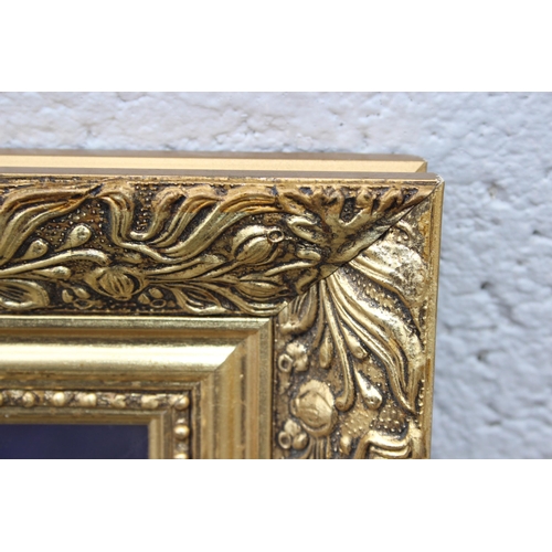 482 - A large decorative gilt framed mirror, approx 113cm x 88cm