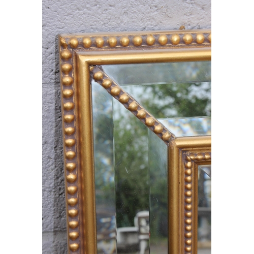 490 - A modern gilt and stepped glass framed mirror, approx 103cm x 79cm