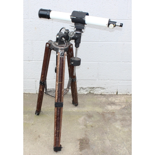 667 - A vintage wooden industrial floor standing tripod with later telescope attachment