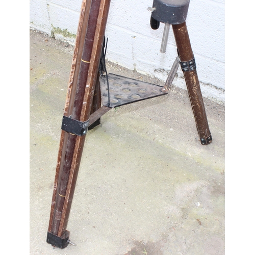 667 - A vintage wooden industrial floor standing tripod with later telescope attachment