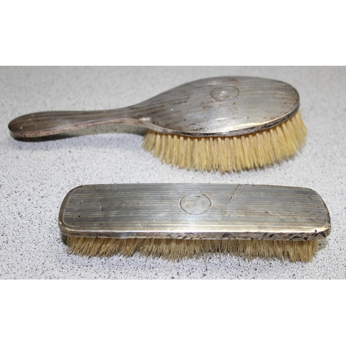 1097 - An early 20th century 4 piece silver backed brush and mirror set with pin striped decoration, variou... 