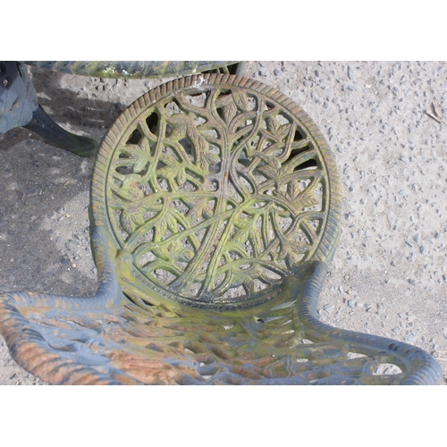 387 - A Victorian style cast iron garden table and 3 chairs, table approx 70cm diameter x 71cm tall