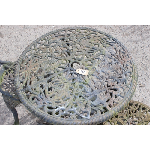 387 - A Victorian style cast iron garden table and 3 chairs, table approx 70cm diameter x 71cm tall