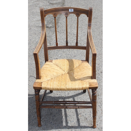 193 - Oak rush seated Arts & Crafts period carver chair with interesting carved detail