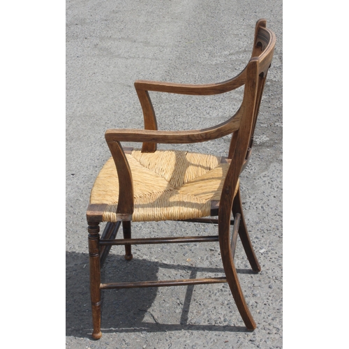 193 - Oak rush seated Arts & Crafts period carver chair with interesting carved detail