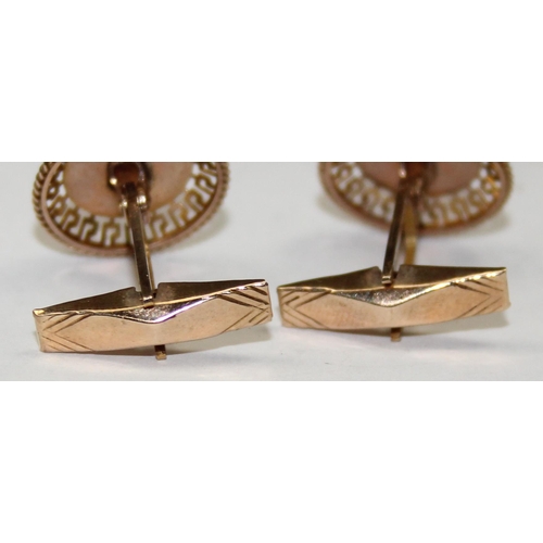 1120C - A pair of mid-century retro 9ct gold cufflinks depicting Viking longboats within a Greek key filigre... 