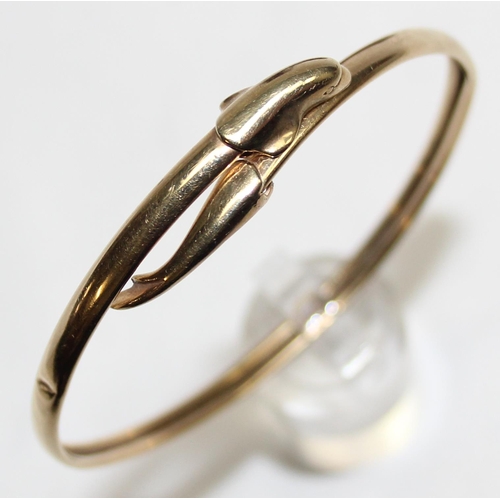 1140P - A 9ct gold torque bangle with dolphin design, marked for Birmingham 1994, approx 5.84g gross, with m... 