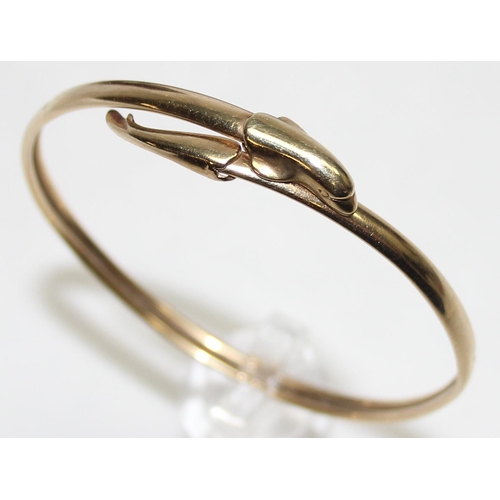 1140P - A 9ct gold torque bangle with dolphin design, marked for Birmingham 1994, approx 5.84g gross, with m... 