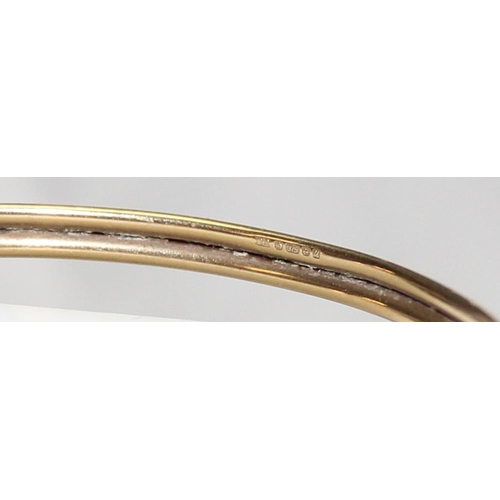 1140P - A 9ct gold torque bangle with dolphin design, marked for Birmingham 1994, approx 5.84g gross, with m... 