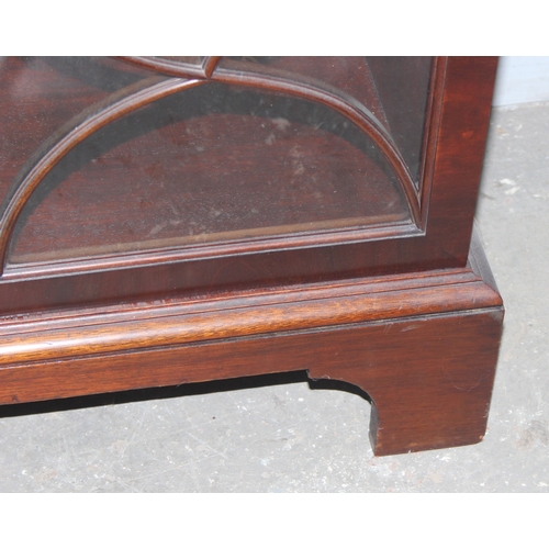 157 - An antique style glazed mahogany bookcase, approx 122cm wide x 32cm deep x 100cm tall