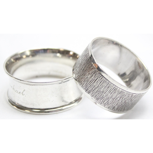 1042 - 2 silver napkin rings, one with retro bark effect design marked for London 1964 by Payne & Son of Ox... 