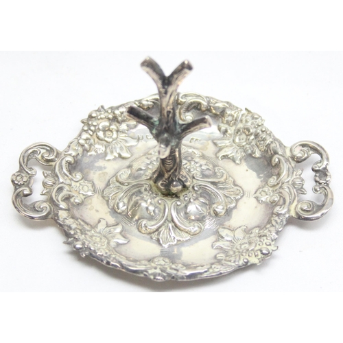 1078 - An Edwardian silver dressing table ring tree with embossed tray, Birmingham 1903 by Robert Pringle, ... 