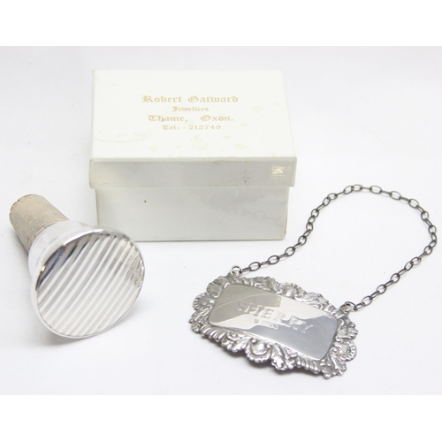 1080 - A boxed silver mounted wine bottle stopper, Birmingham 1996 and silver Sherry decanter label (2)