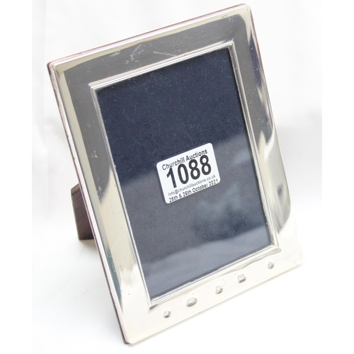 1088 - A plain silver photograph frame with prominent hallmarks and easel back, marked for Sheffield 2000, ... 