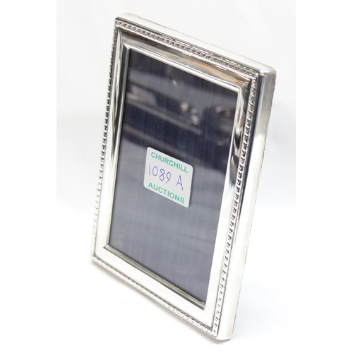 1089A - A silver photograph frame with rope twist border and easel back, marked for Sheffield 1992, approx 1... 