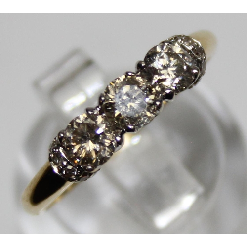 1110B - A vintage 18ct gold trilogy diamond ring, set with 3 larger diamonds and smaller diamond shoulder mo... 