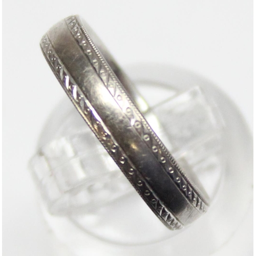 1110D - An 18ct white gold band ring with engraved decoration, approx size O, approx 4.33g gross