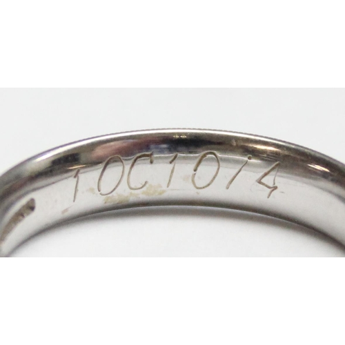 1110D - An 18ct white gold band ring with engraved decoration, approx size O, approx 4.33g gross