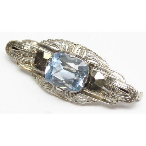 1110E - An interesting 18ct white gold and blue stone brooch, possibly an aquamarine, assessed as approx 7ct... 