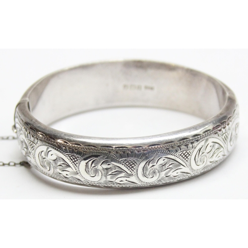 1195 - A vintage silver cuff bangle with engraved decoration, Birmingham 1968, and an unmarked vintage silv... 