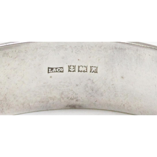 1195 - A vintage silver cuff bangle with engraved decoration, Birmingham 1968, and an unmarked vintage silv... 