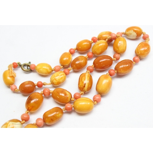 1198 - A vintage Amber bead necklace, a mixture of oval and cylindrical beads with alternate circular coral... 