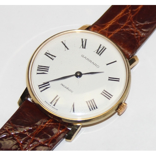 1334 - A vintage Garrard gold plated watch with mechanical movement, crocodile effect leather strap and ori... 