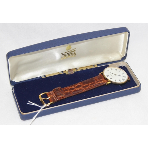 1334 - A vintage Garrard gold plated watch with mechanical movement, crocodile effect leather strap and ori... 