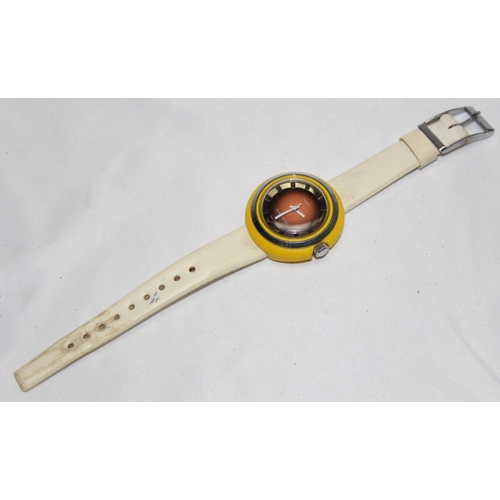 1346 - A retro Timex wrist watch with yellow plastic and stainless steel case and cream vinyl strap, the ca... 